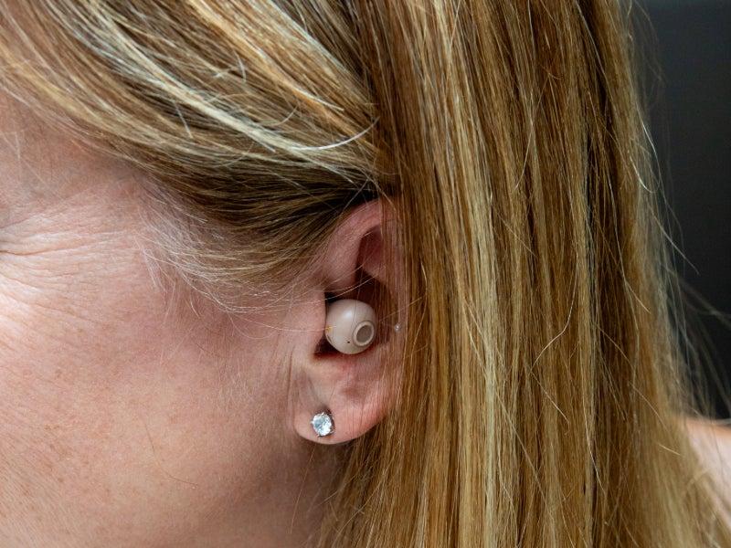 A woman's ear with the Audien Atom Pro 2 snugly fit in the canal