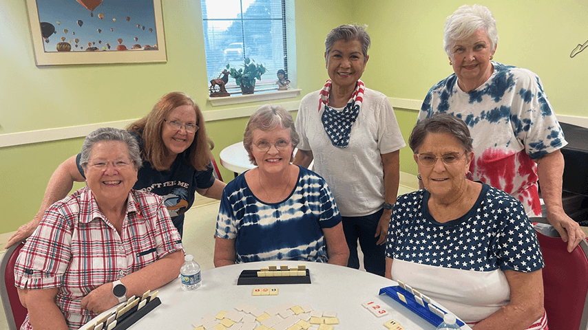 Smiling older women playing rummikub