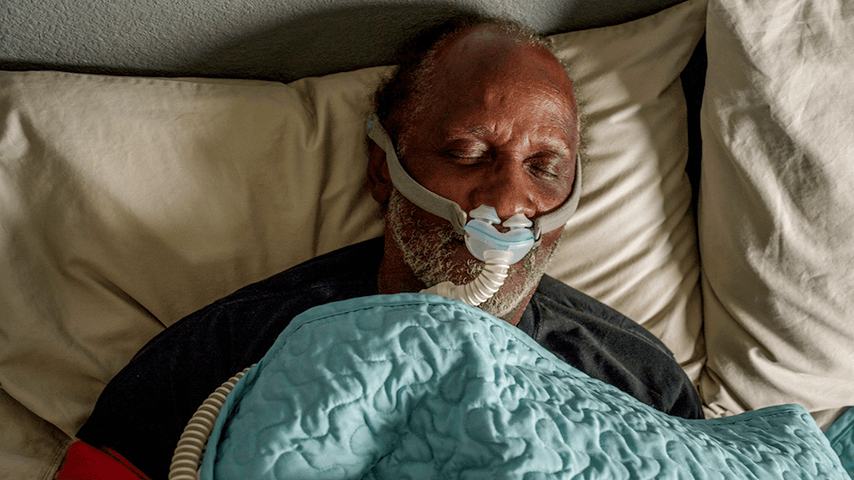 older black man asleep with CPAP mask on