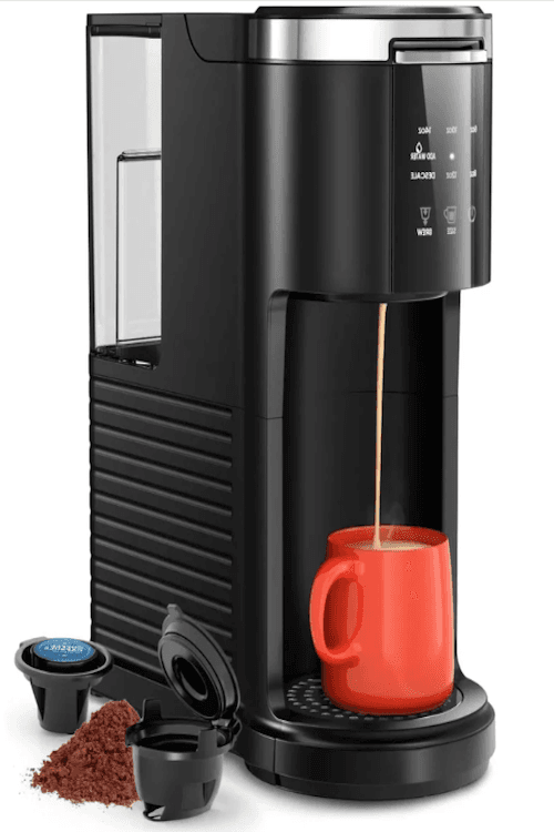 Black single-serve coffee maker, making a cup of coffee in an orange mug”