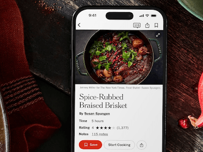A smart phone showing a recipe for spice-rubbed braised brisket, with an accompanying image of the dish.