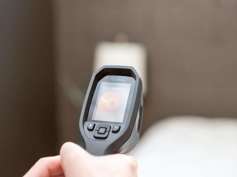 A heat gun aimed at the mattress shows a reading of 72 degrees.