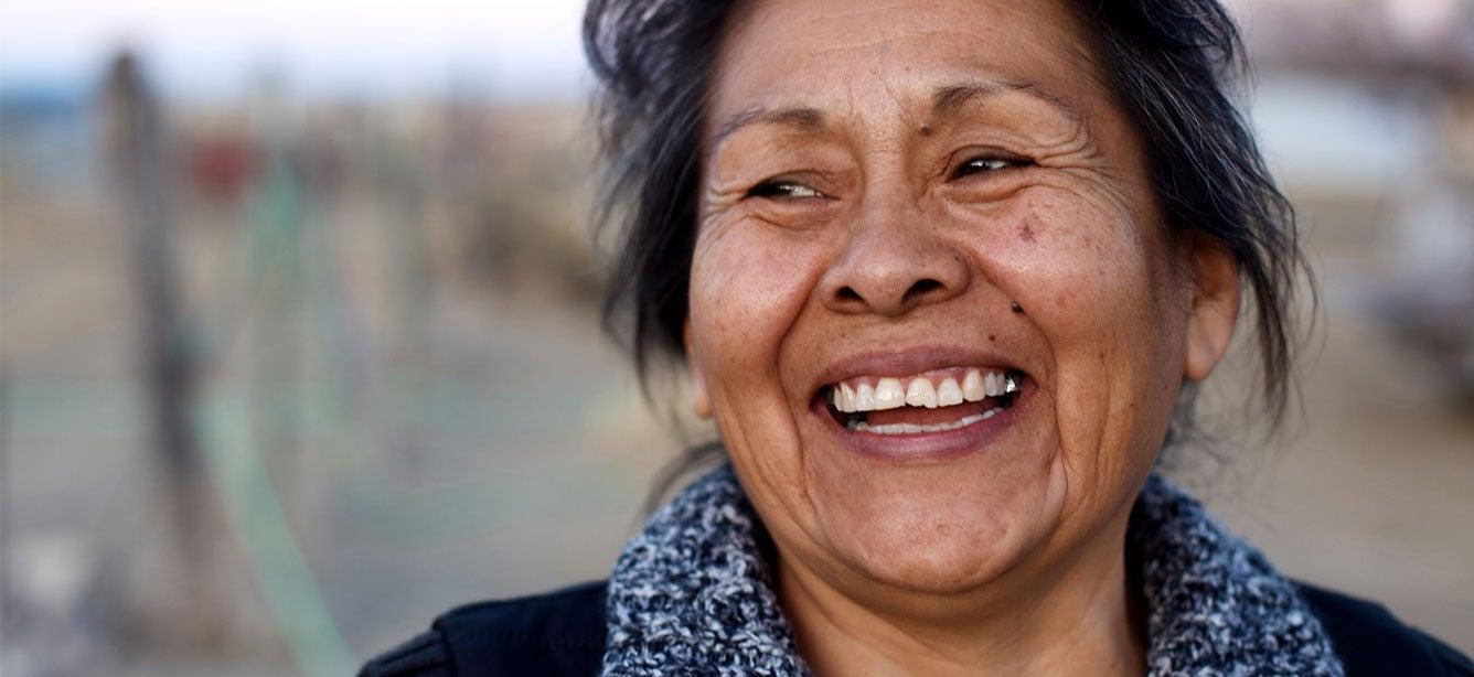 An up close shot of a senior Indigenous female seen outside smiling.