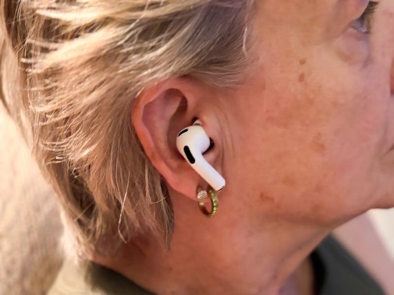 A woman wears the Apple AirPods Pro 3