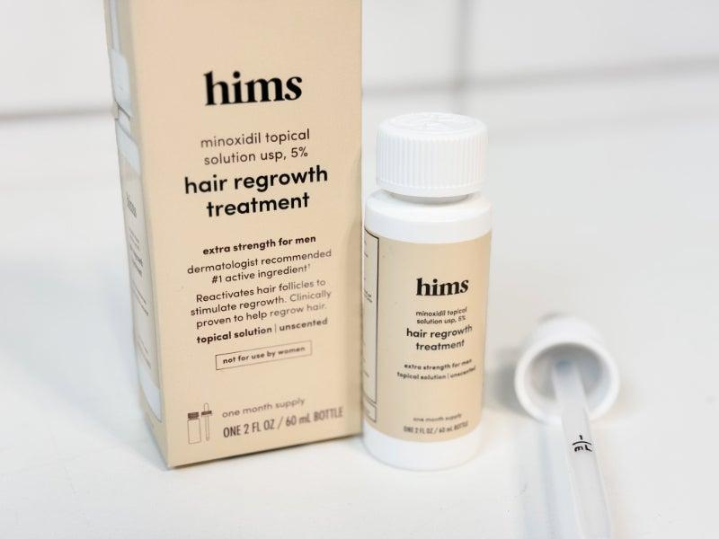 A box of Hims Hair Regrowth Treatment with Minoxidil and a bottle and dropper