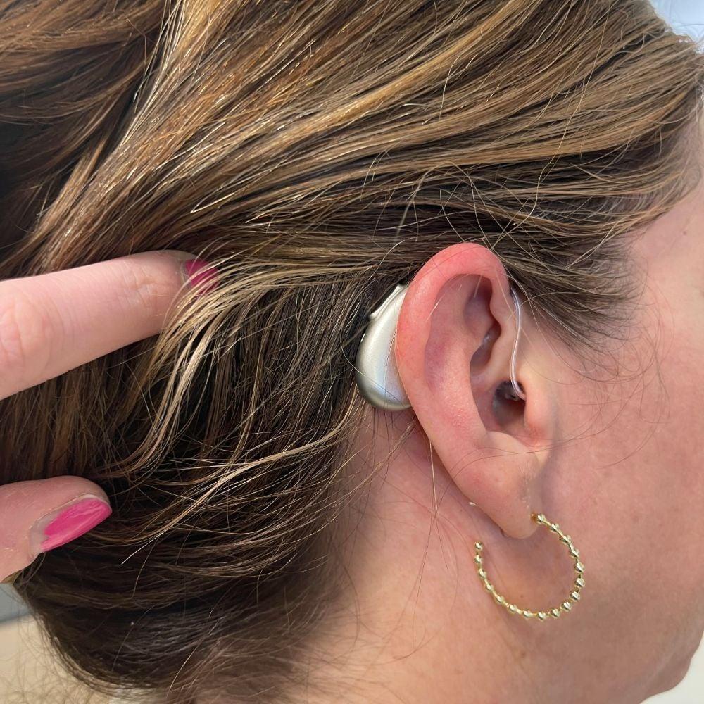 A woman wearing the ELEHEAR Beyond hearing aids