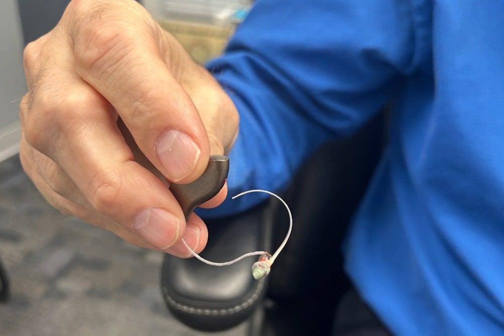 hand holding a Starkey hearing aid