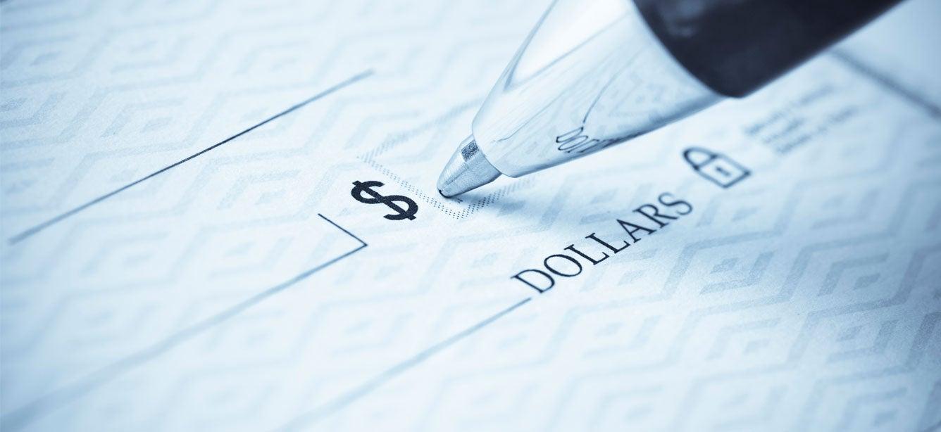 close-up of a ballpoint pen on a bank check