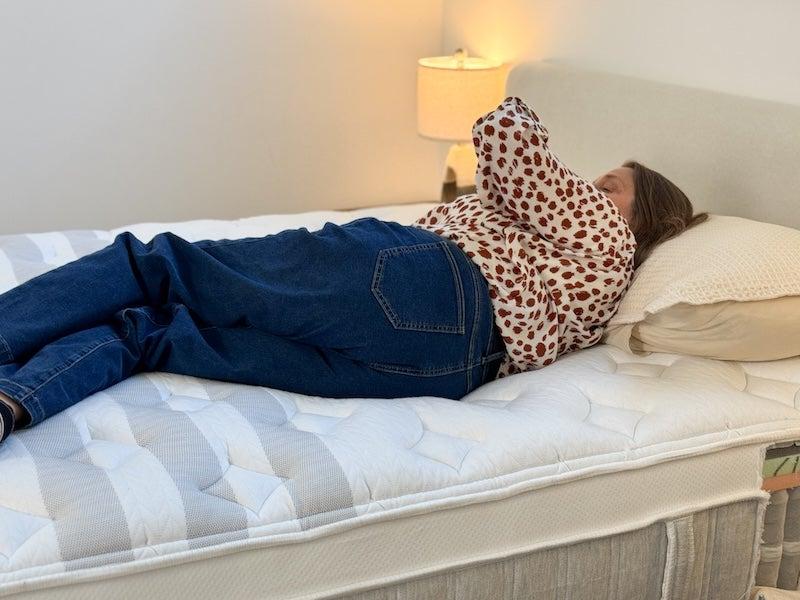 A woman rolling onto her side on the Leesa Sapira Chill mattress