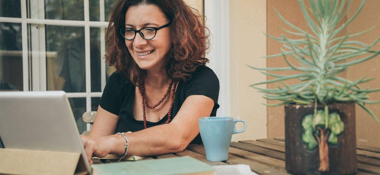 smiling woman working on computer tablet
