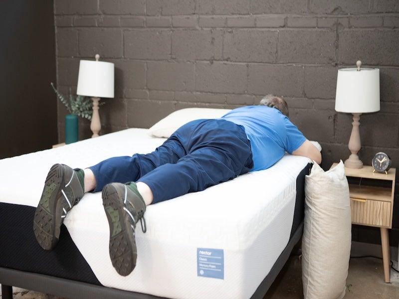 A man lies face-down on a Nectar Classic Memory Foam mattress
