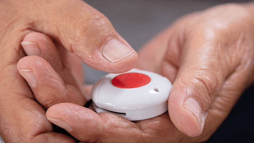 hands holding a medical alert system button