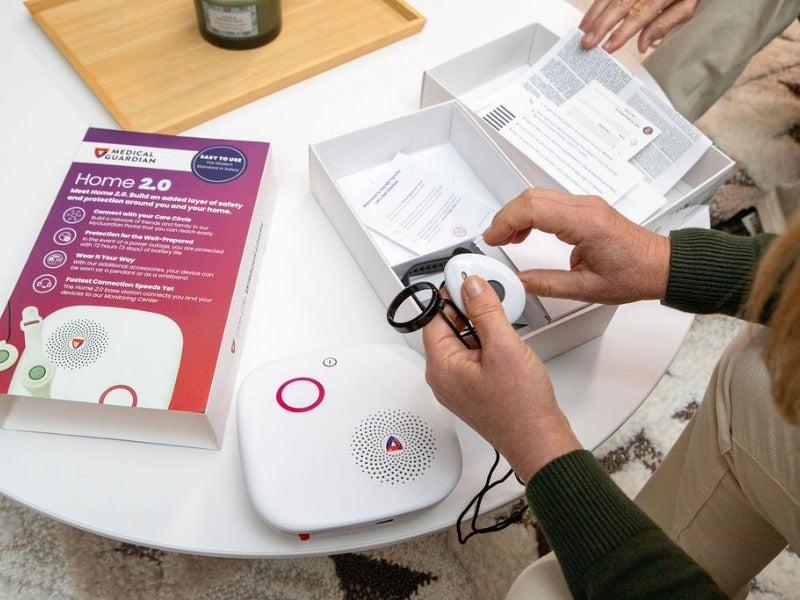 A person taking the parts of the MGHome Cellular out of its box