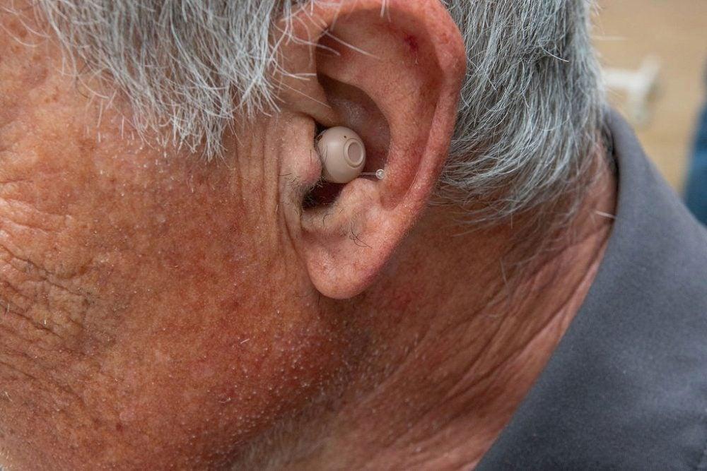 Audien Atom Pro hearing aid in man's left ear
