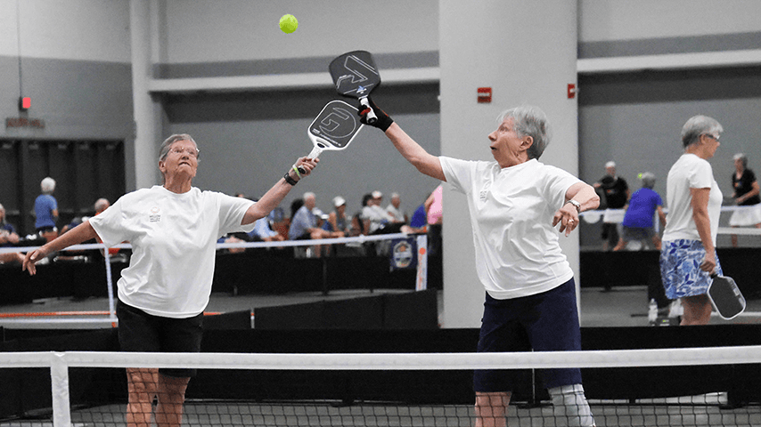 two older women going for pickleball overhead