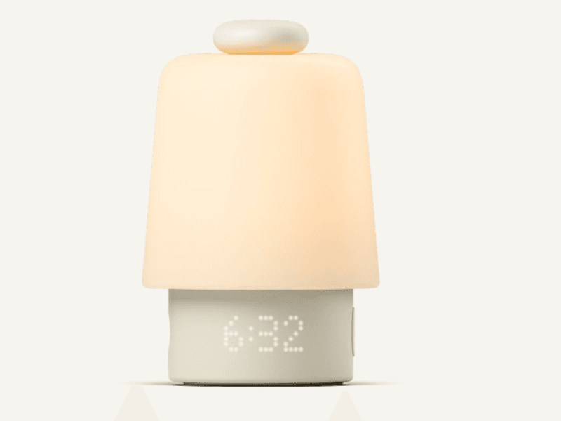 Clock with a domed top in soft, neutral colors and time reading “6:32.”