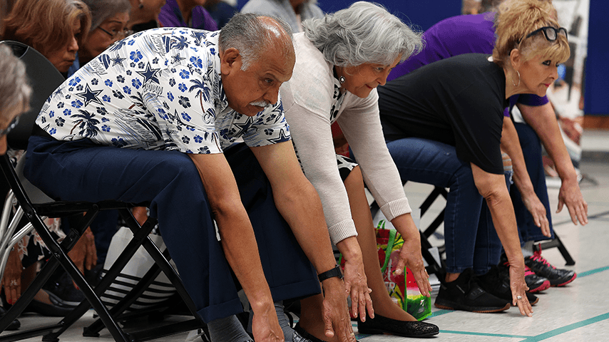 Older adults doing chair yoga