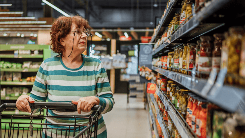 An older woman shops at a grocery store