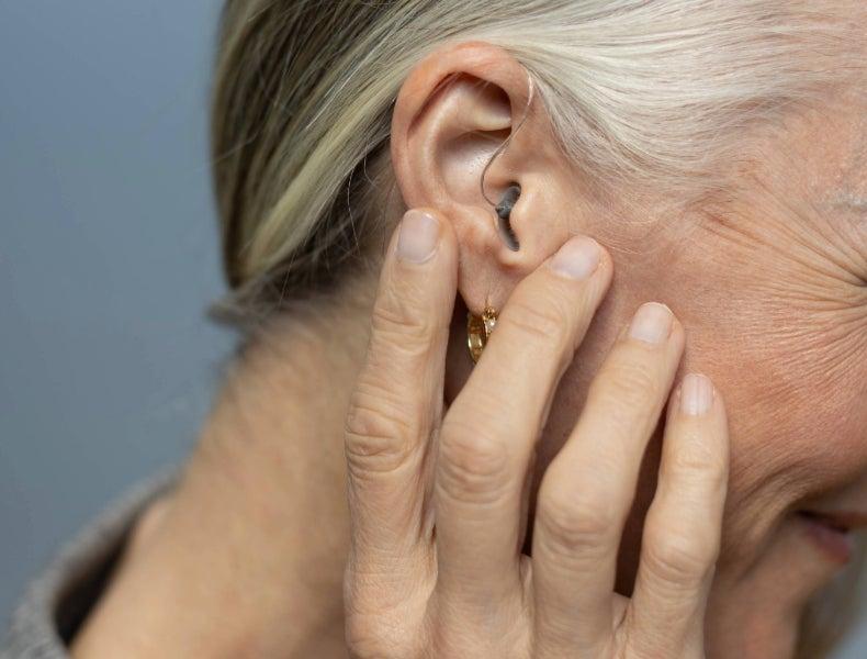 A woman wearing the Jabra Enhance Select M2 hearing aids