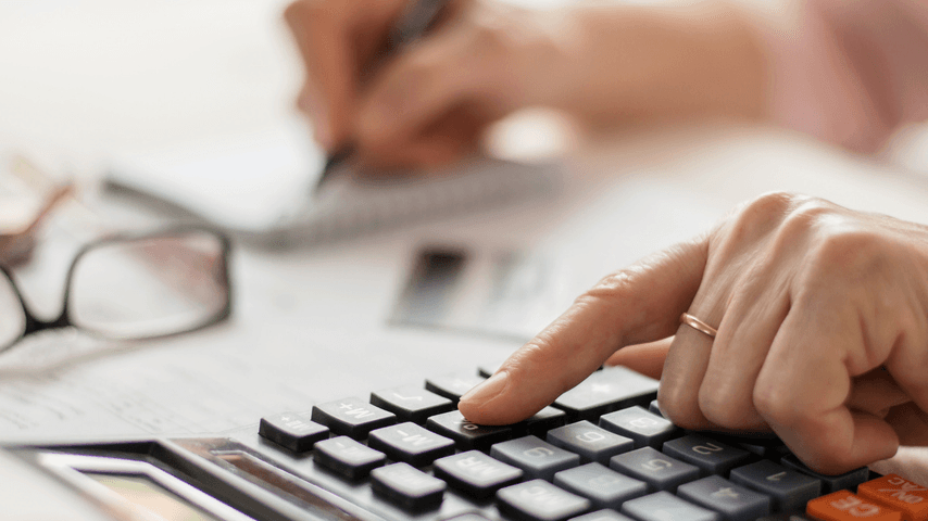 A hand using a calculator