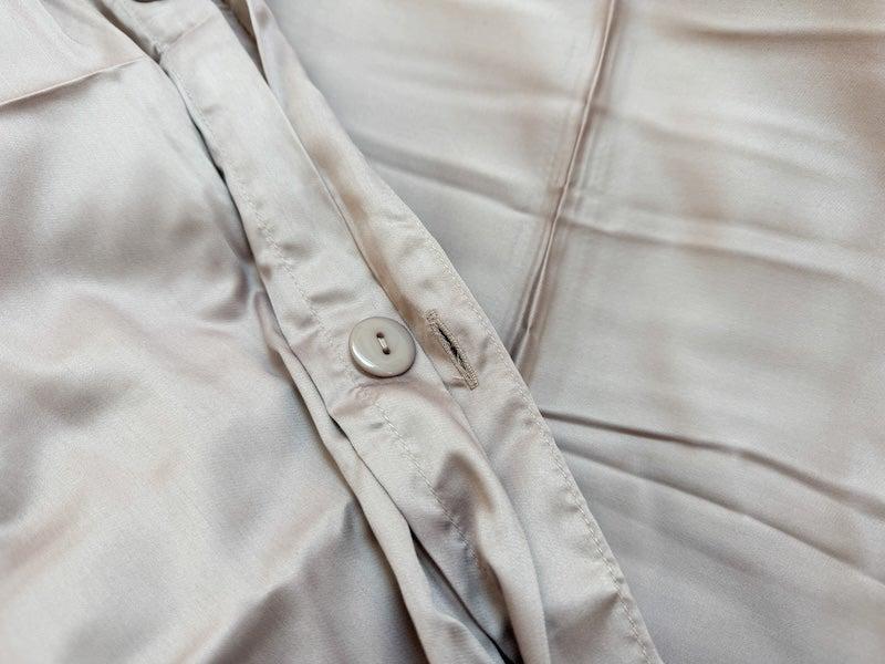 A closeup of the button closure of the Nest Bamboo Duvet Cover
