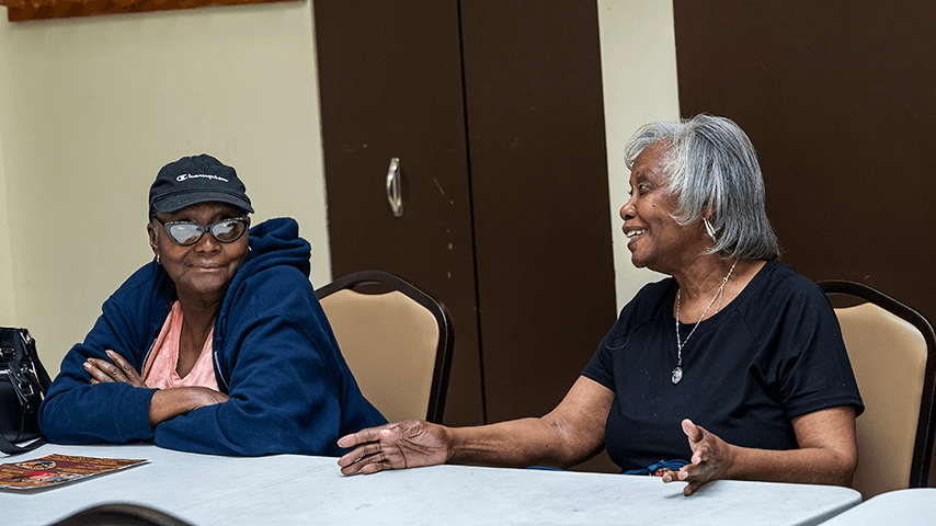 two smiling women in senior center classroom