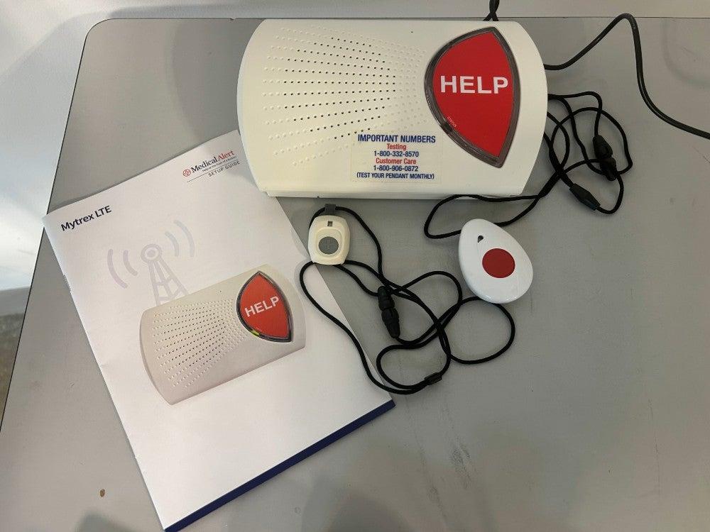 Medical Alert’s home system’s base station, help button, fall detection button, and user manual