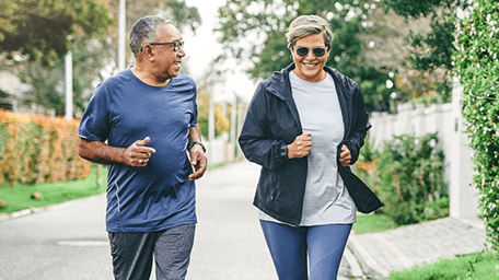 smiling man and woman on a power walk
