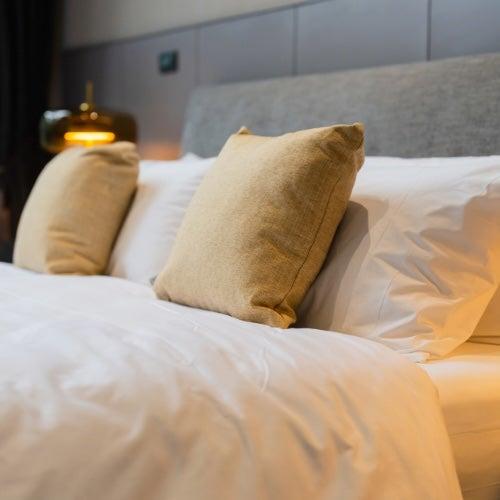 A bed with lots of fluffy pillows on it