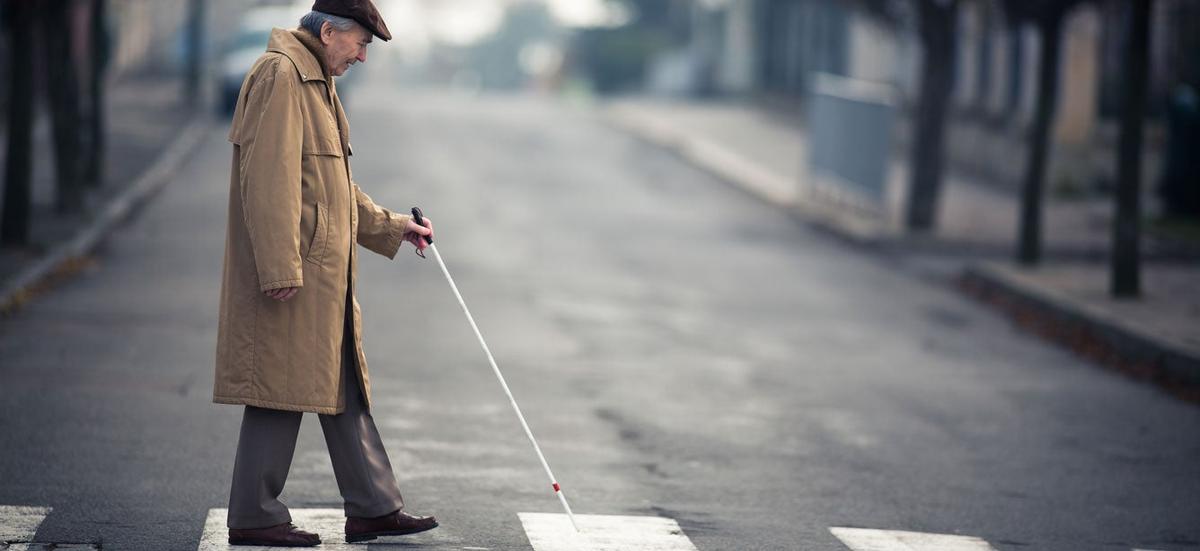 Person with vision loss crossing a street
