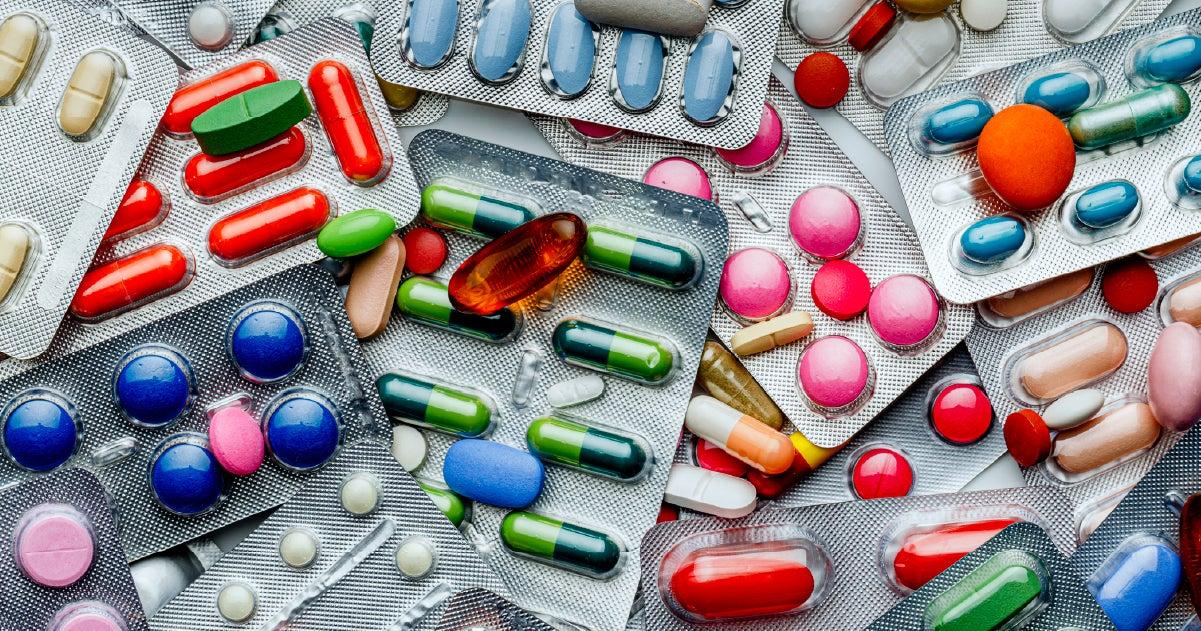 multicolored pills, some loose and some in blister packs