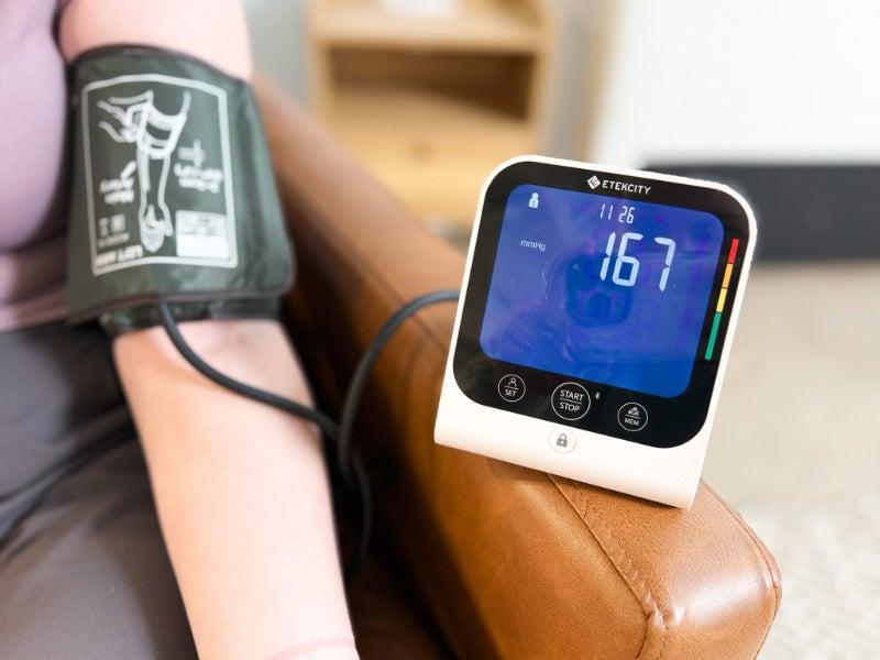 The Etekcity TMB-1583-BS blood pressure monitor on a tester's arm