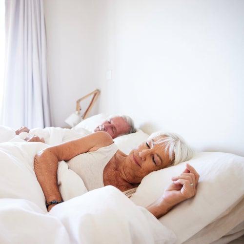A man and woman sleeping peacefully in a bed