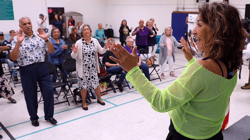smiling instructor leads falls prevention dance class