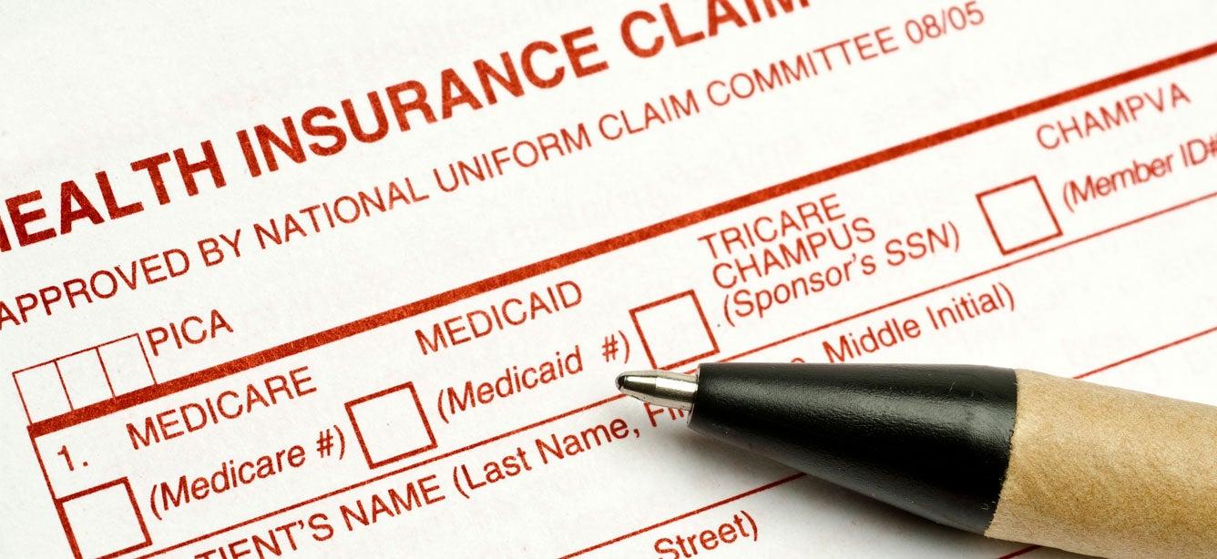 Close up shot of a Medicare health insurance claim form and a pen.