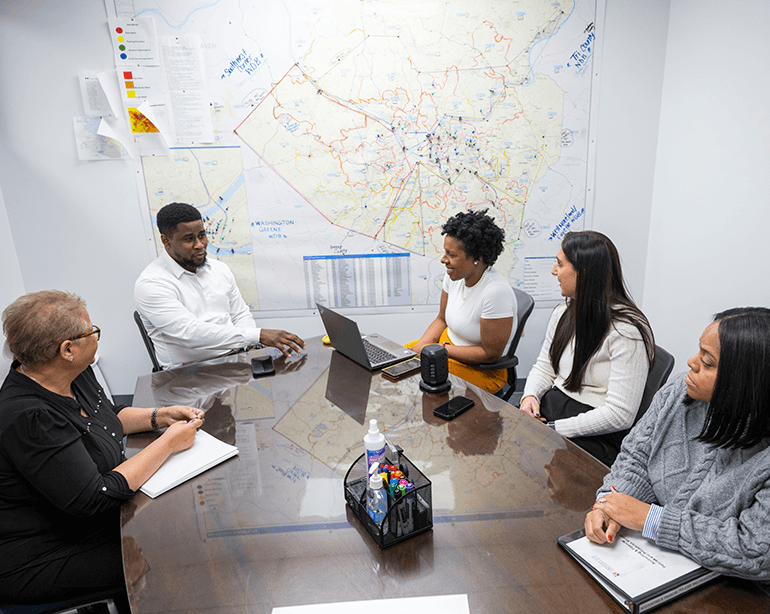 age-diverse group of professionals around a conference table