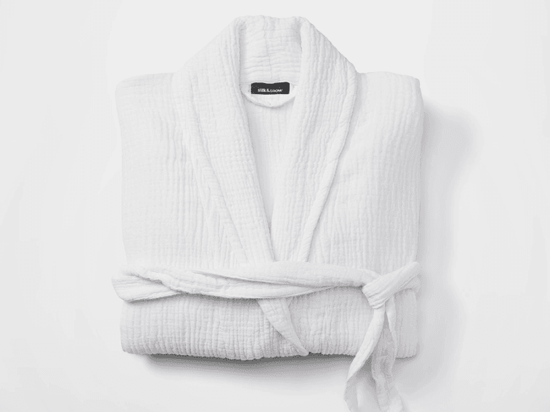A white Silk & Snow Muslin robe against a white background