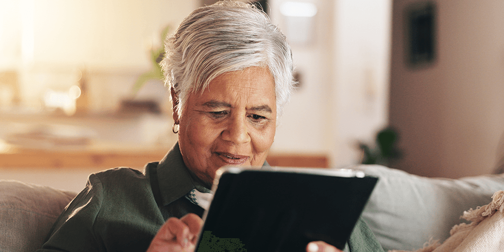 older black woman using computer tablet
