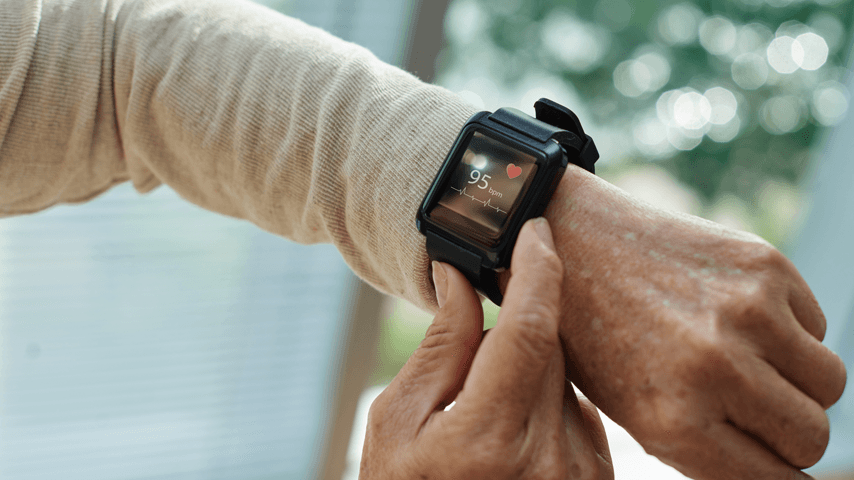 A senior person is monitoring their heart rate zone via their smart watch.