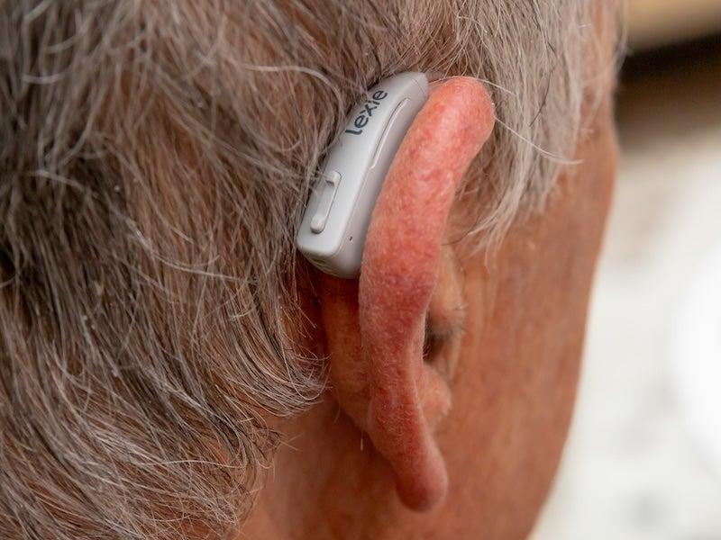 A man wears the Lexie B2 Plus hearing aid
