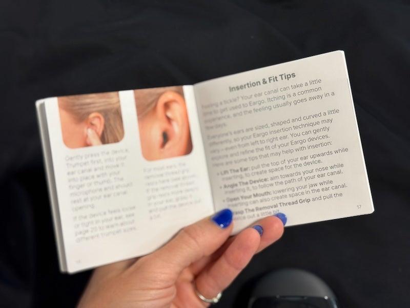 A woman reads the Eargo 8 user manual