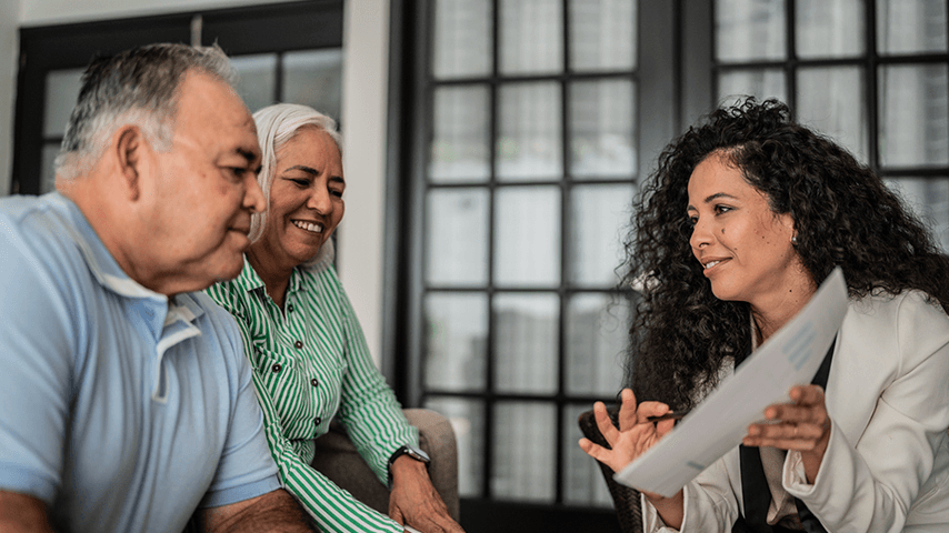 Two older adults speak with an advisor