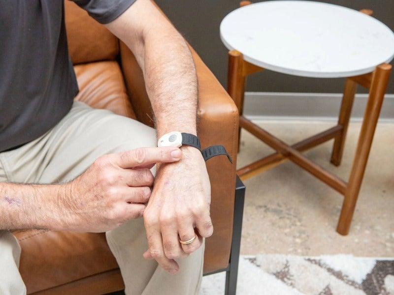 A man wearing the Medical Alert Home System’s help button on his wrist