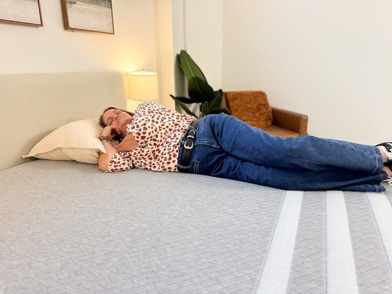 A woman lying on her side on the Leesa Original memory foam mattress