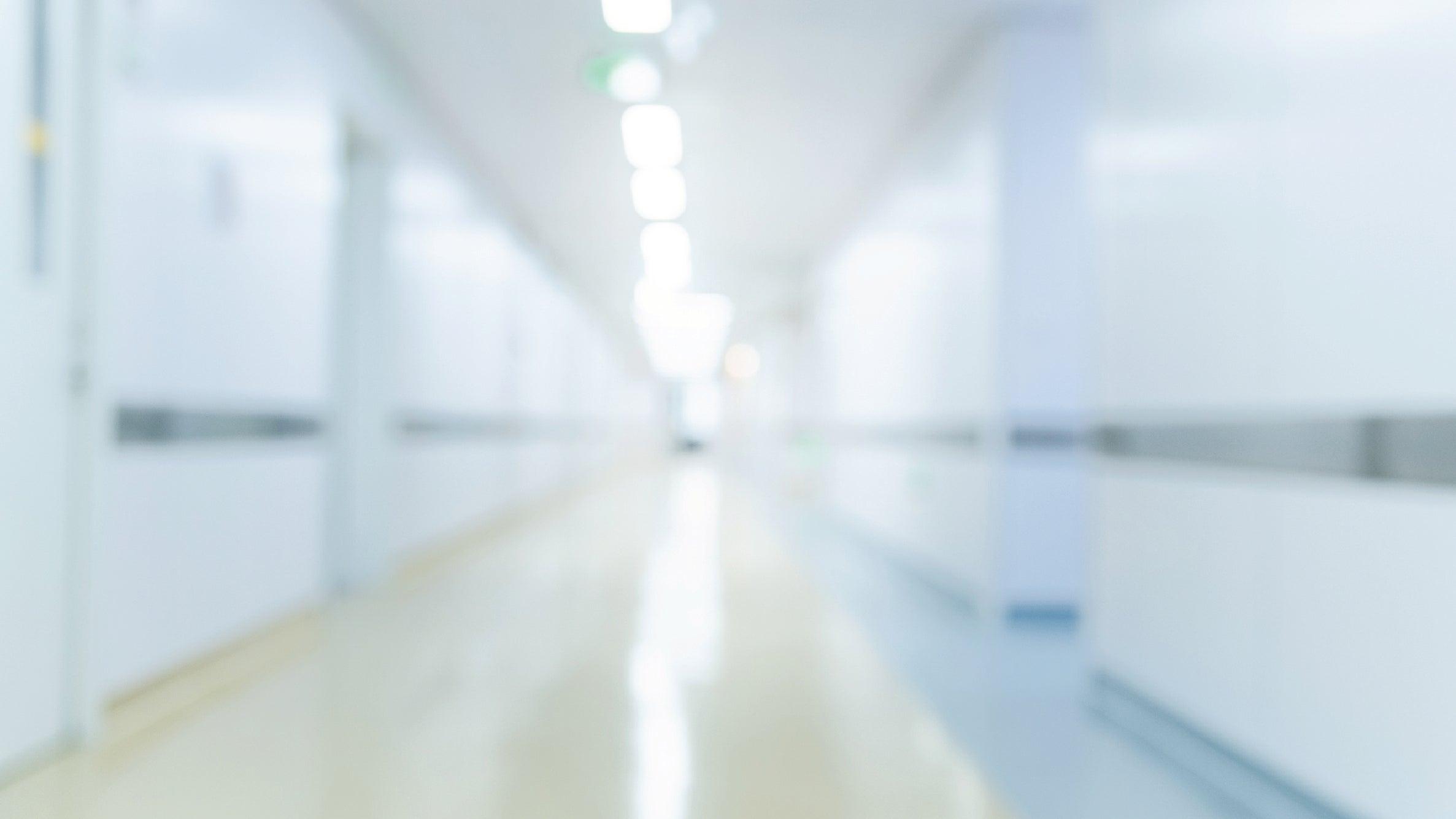 A sterile and empty hallway in a hospital's emergency room.