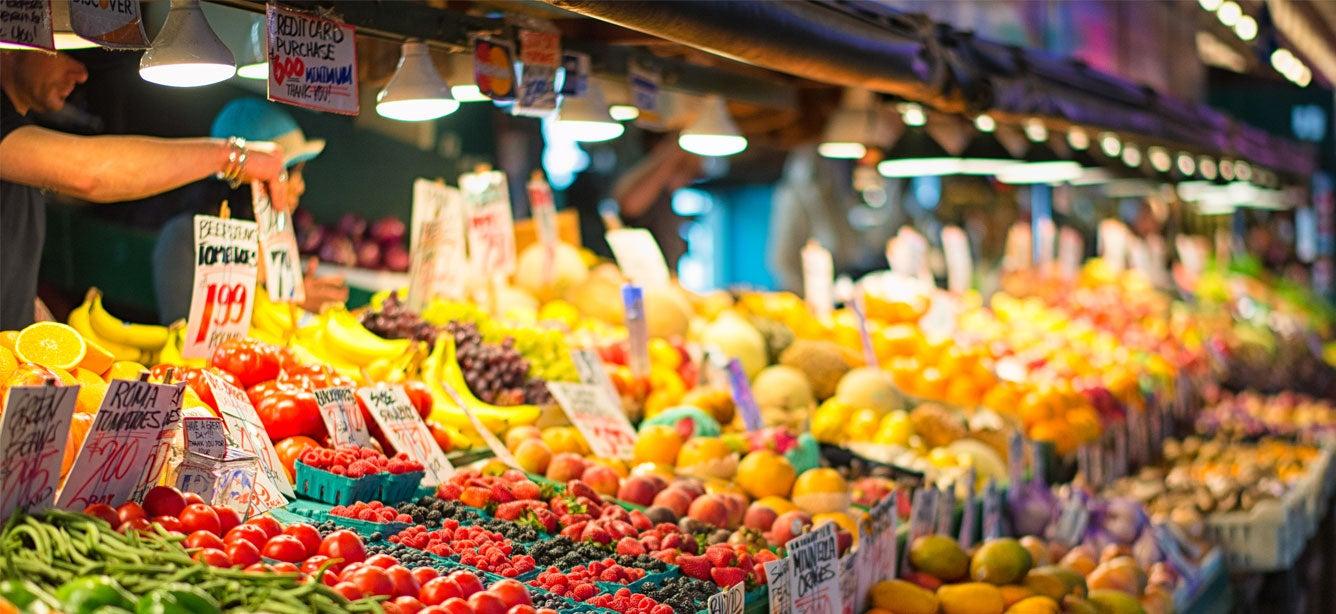 A farmers market stand loaded with fresh fruits and vegetables (Pike Place in downtown Seattle).