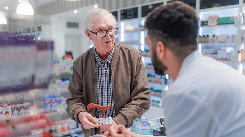 older man talking to pharmacist
