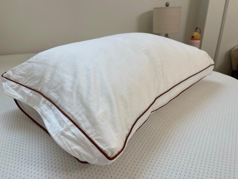 The high-loft Saatva Latex pillow on a mattress without sheets