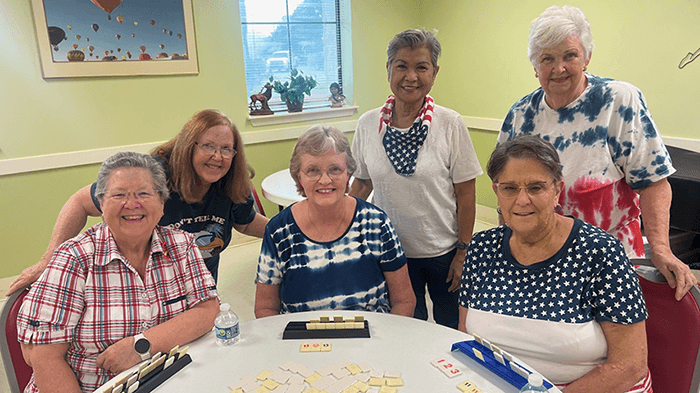 smiling women playing Scrabble at senior center