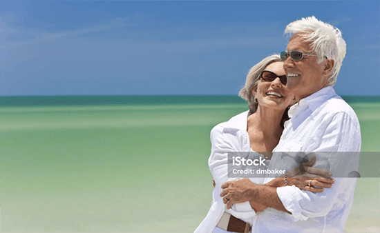 iStock image of smiling older couple on beach